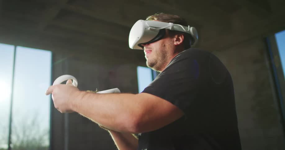 A man is playing a virtual reality game indoors
