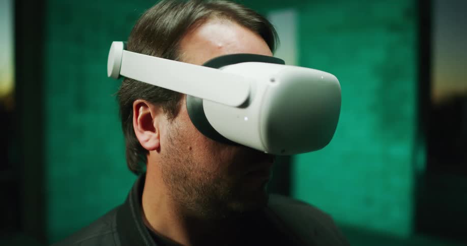 A man wearing virtual reality glasses is looking around