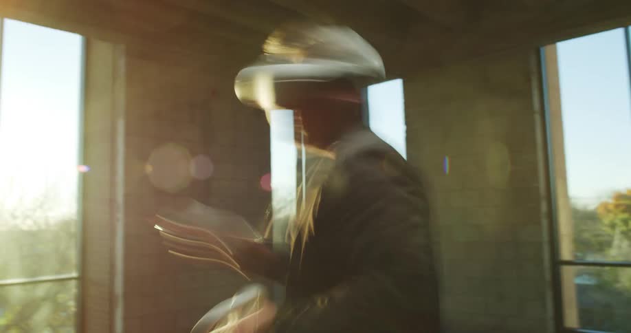 A man moves his hands back and forth as he plays a virtual reality game