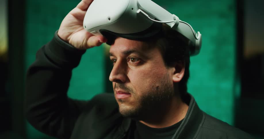 A man taking off a virtual reality headset