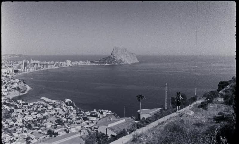 Video footage of a town near the ocean coast is displayed