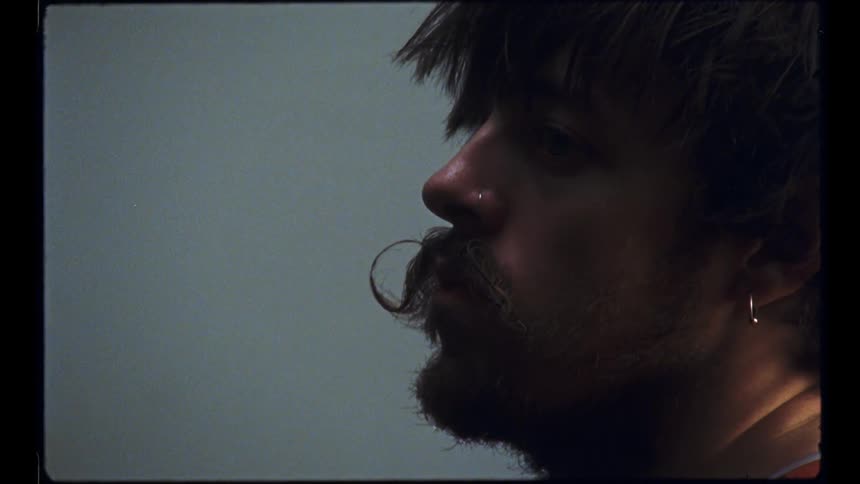 Close up view of a man with a beard is displayed