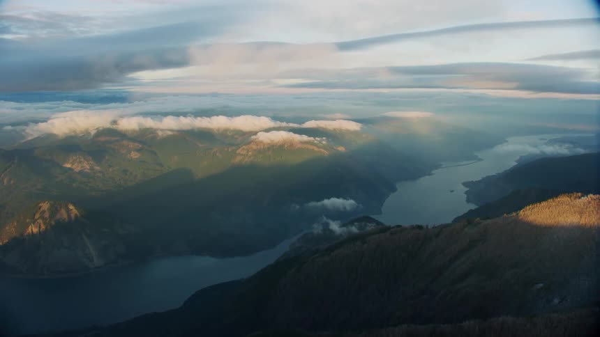 The Columbia river slices a dramatic gorge through frost covered peaks at sunset