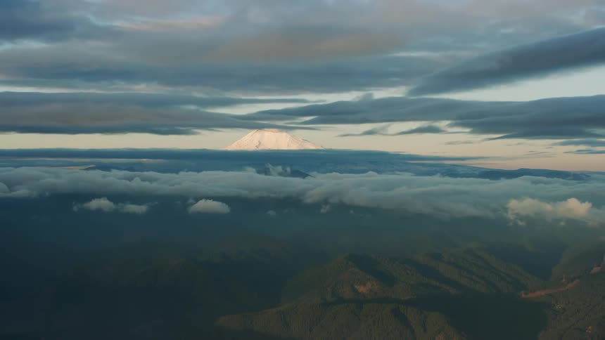 Layered perspective zoom out from a snow covered peak to pristine and protected wilderness