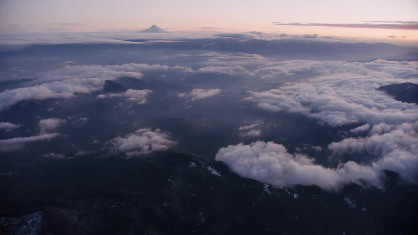 Wide blue hour dusk shot high above earth with Mount Hood in the background.