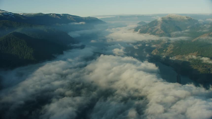 High altitude aerial show with stunning clouds obscure a massive Columbia river gorge and rising hills to either side