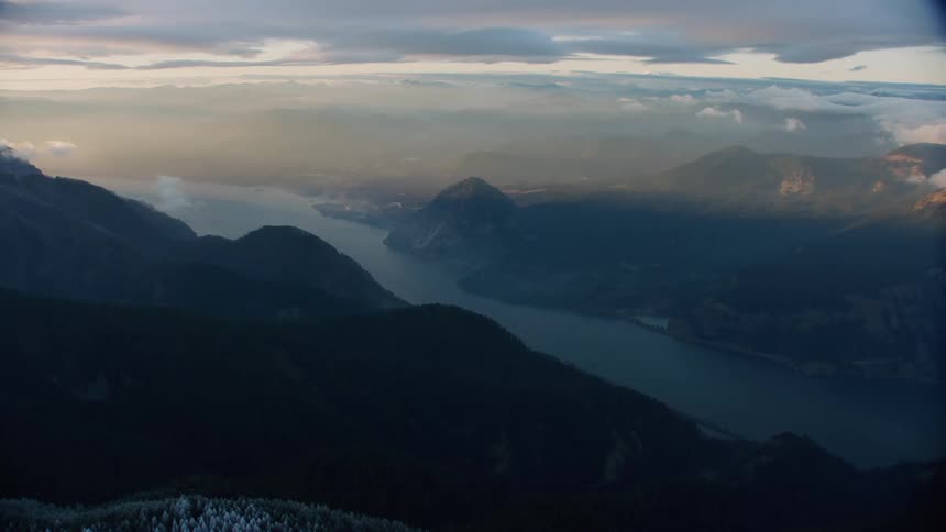 Blue hour reveal of snow covered ridge with majestic Columbia River and Wind Mountain in the background