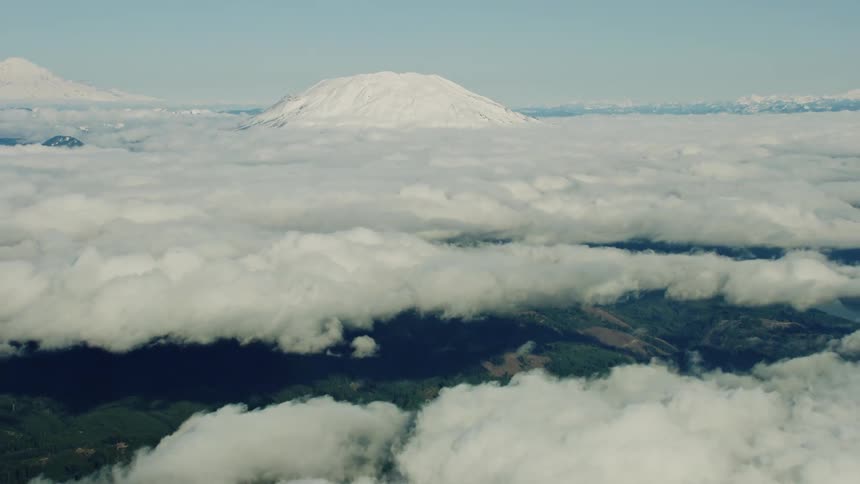 Hyper Lapse revealing thick rolling dynamic fog bank in front of Mount St Helens and Mount Rainier