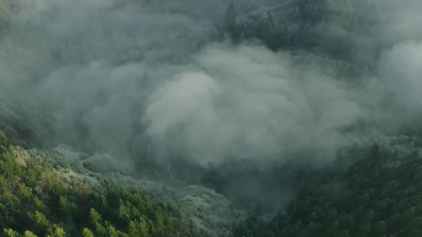 Dynamic shot of fog obscuring a river valley