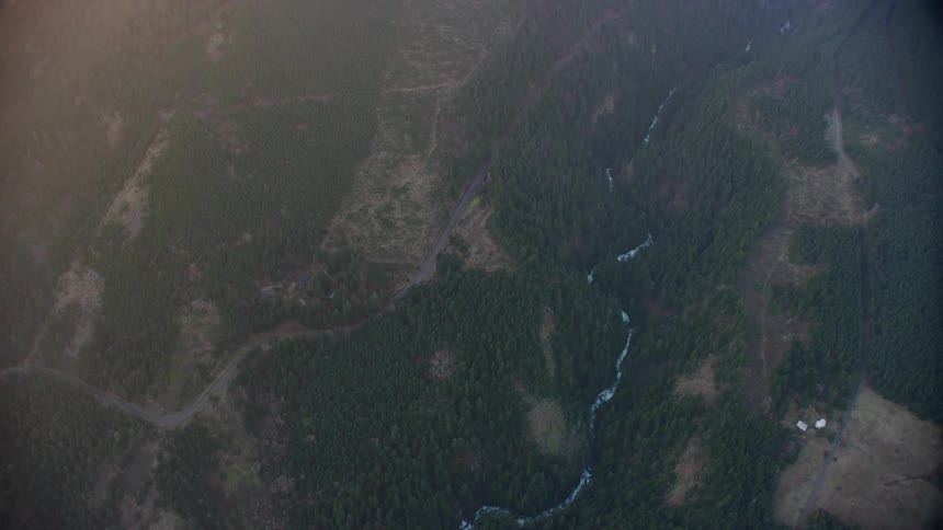 Birds eye view of a dramatic river valley full of waterfalls at sunset