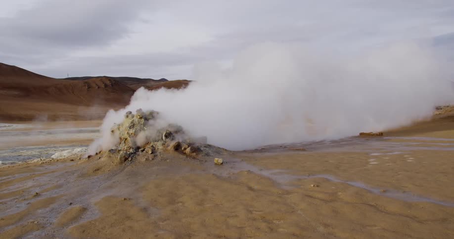Large cloud of smoke billows from a pile on the sand