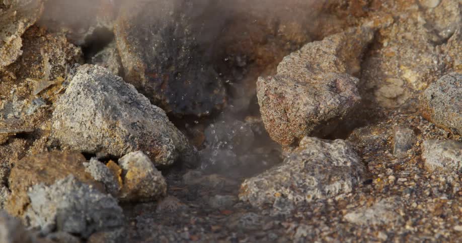 Water bubbles and smokes between some rocks