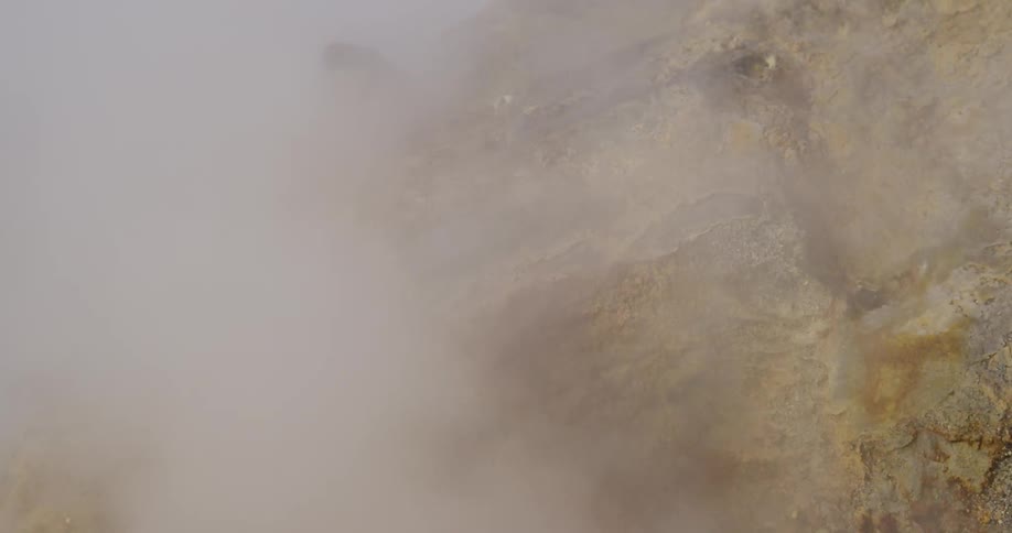 Steam is rising on the side of rocks