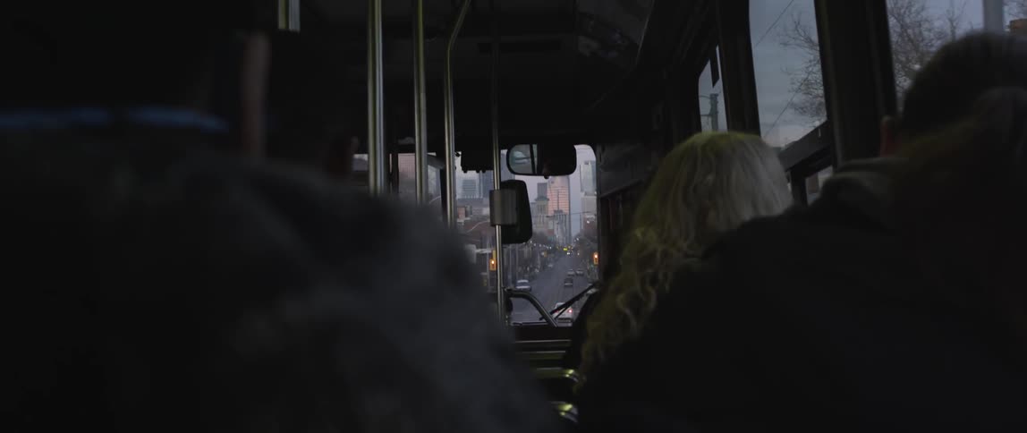 A bus transports people down a city street