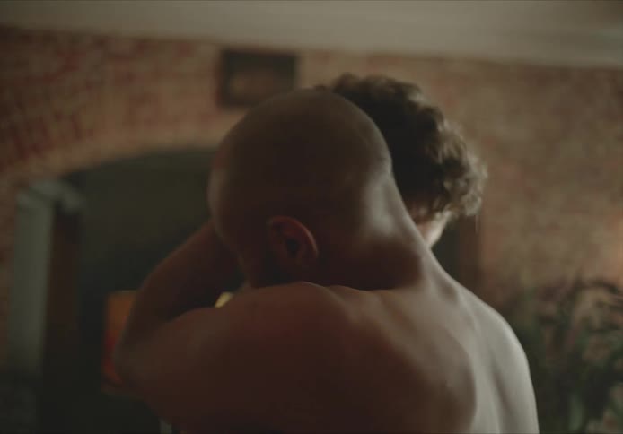 Two men dance and hug at home