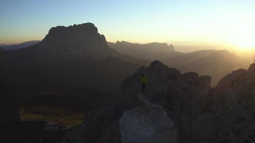 A man is walking on the edge of the cliff