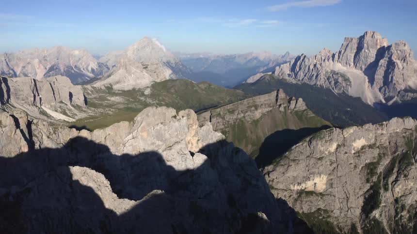 Rough mountainous terrainpartly in shadow stretches to the misty horizon