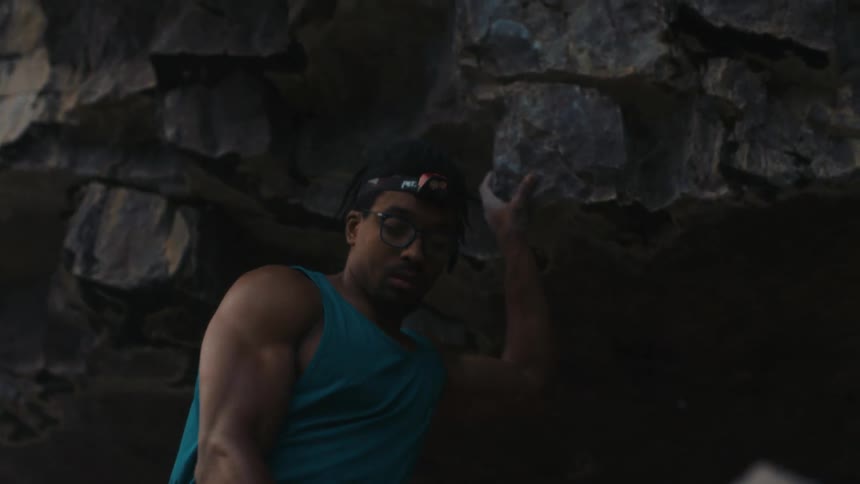 A rock climber makes his way up the side of a mountain