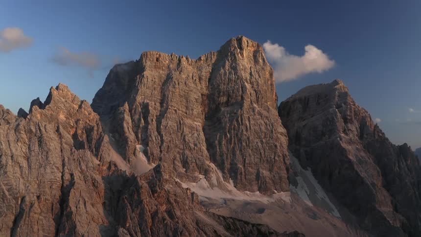 The tall mountain is partially covered in shade