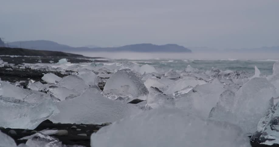 Large pieces of ice sit on the shore