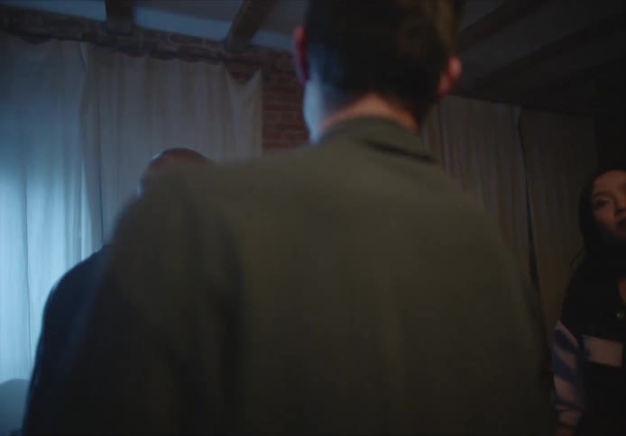 A group of friends smile and laugh as they dance at a house party