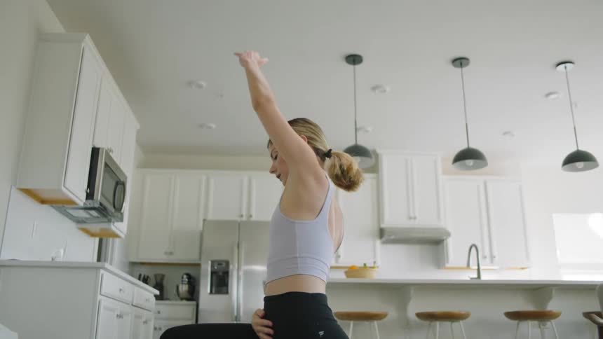 A woman is doing yoga at home