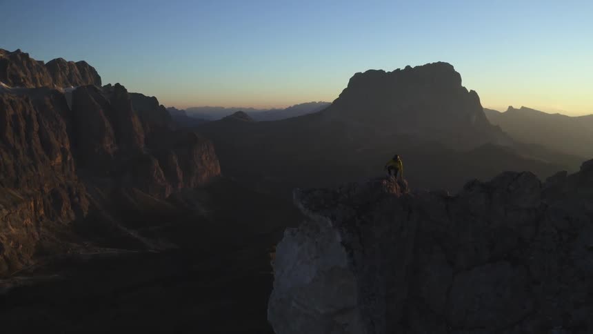 A rock climber walks on the top of the mountain