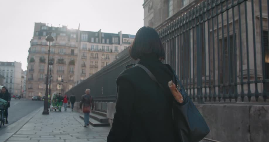 Pedestrians travel on the sidewalk in the city