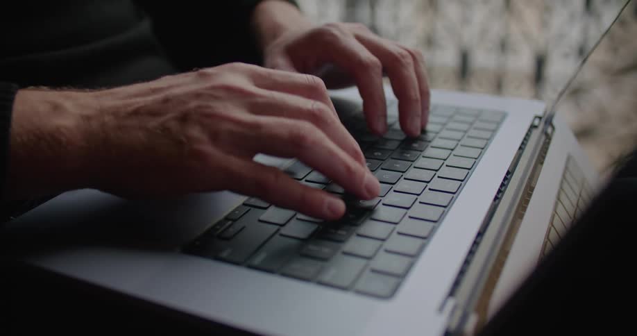 A person typing on a laptop
