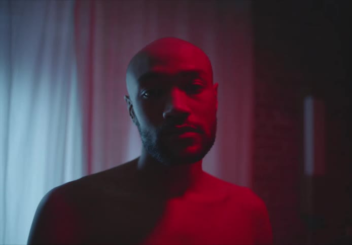 A portrait of a man in a room with red lights