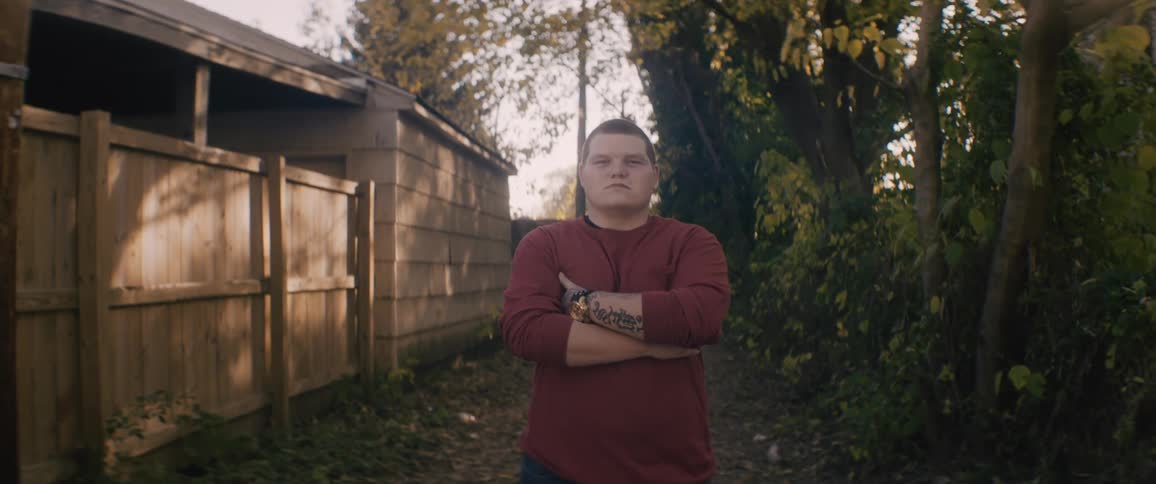 A portrait of a man standing outdoors