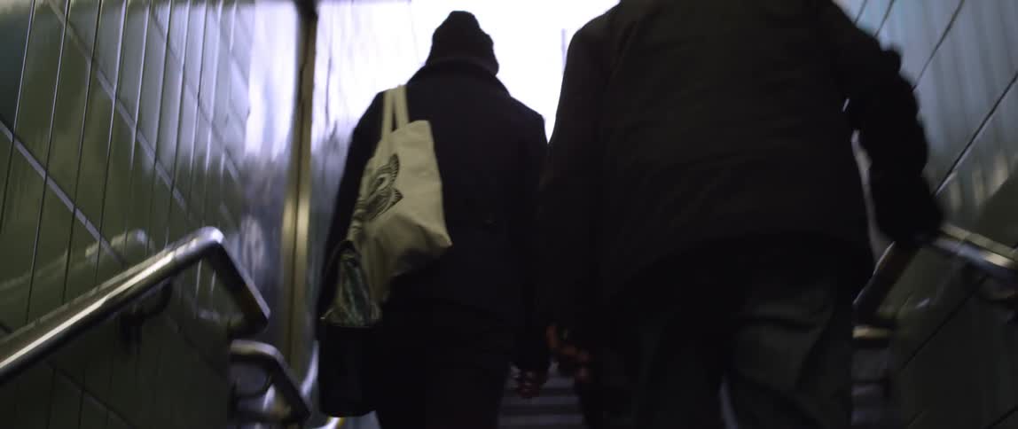 People are climbing steps out of a subway