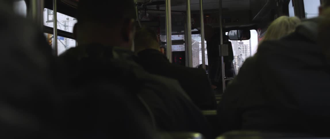 A person gets on a crowded bus