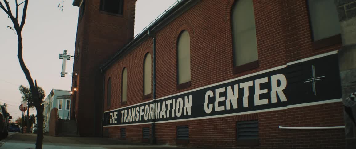 A man walks in front of a religion based treatment center in a neighborhood