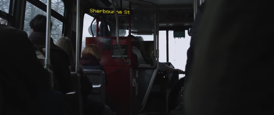 People are riding a bus on a cloudy day