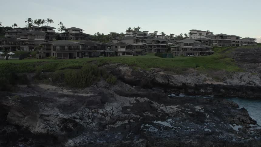 Aerial view of buildings on cliff next to sea