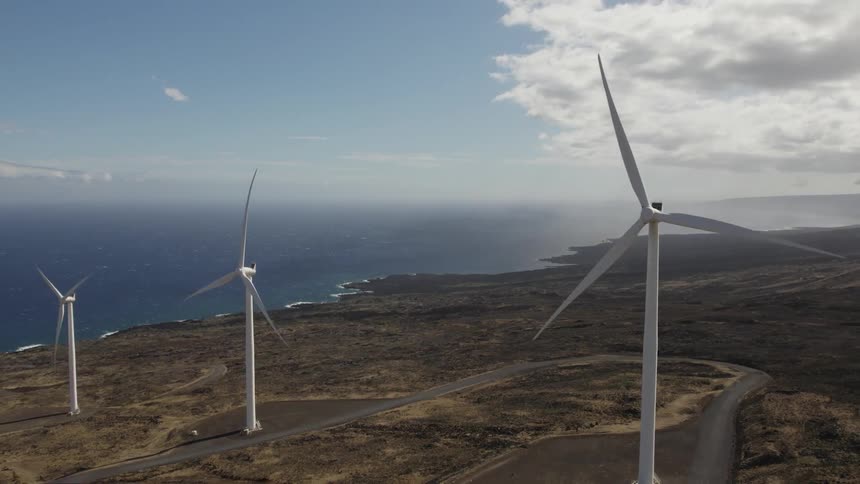 Turbines spinning on a wind farm along the coast