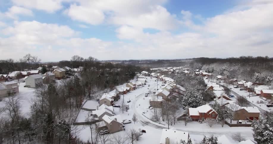 Aerial view of a neighborhood that is covered with snow