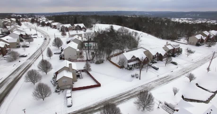 Aerial view of a residential area covered with snow