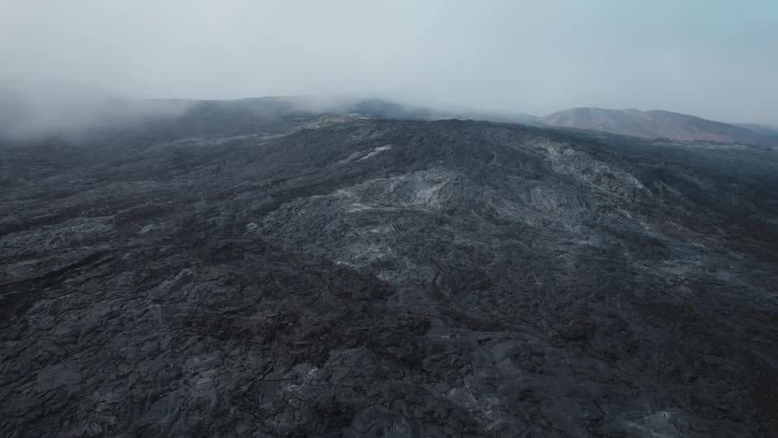 Heavy fog settles over mountain terrain