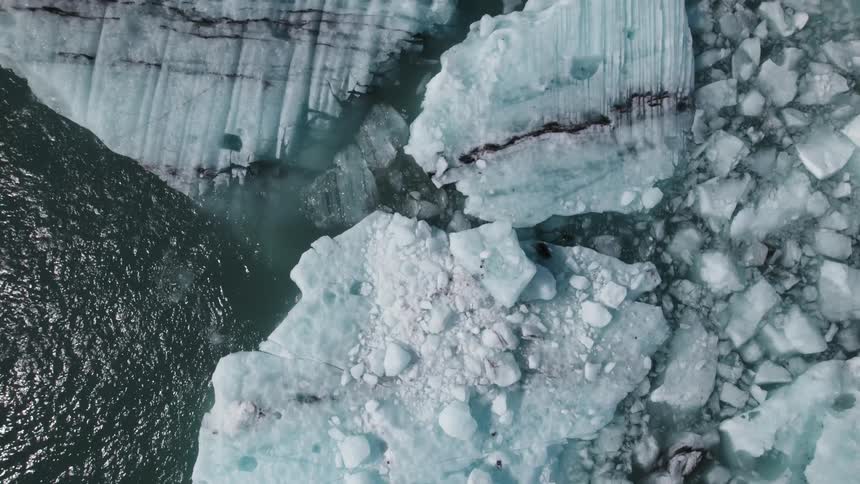Large blocks of ice floating on the rippling ocean surface