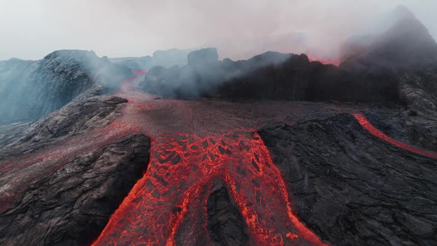 Thick red lava pours out of a volcano