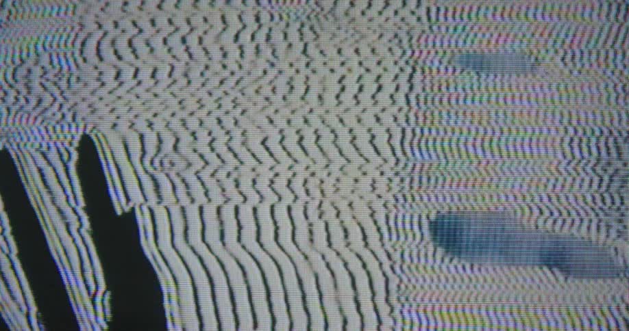 A strange face and the silhouette of a hand moves on a screen surrounded by dark blue and white lines moving around it