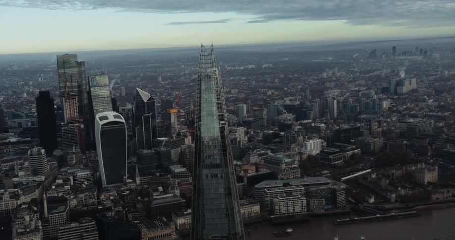 Aerial view of city towers with high rise buildings next to river in city