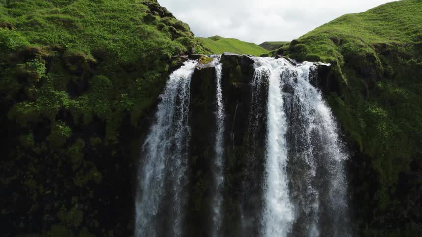 An aerial view of a river leading to a waterfall