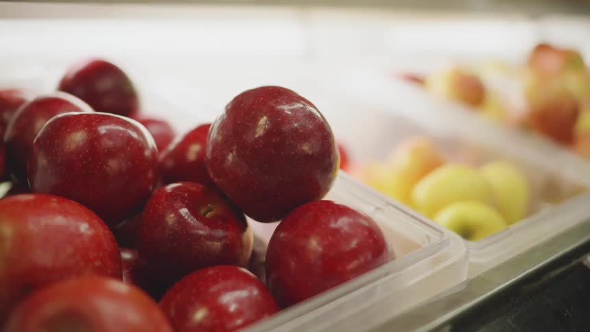 Bins of apples and produce in a market