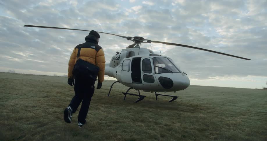 A man walks to the helicopter