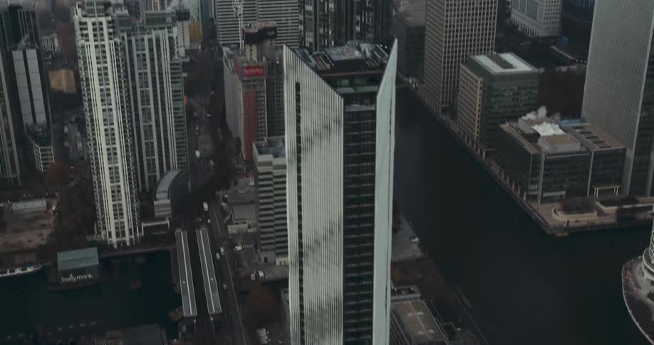 A river cuts and winds through a city with skyscrapers
