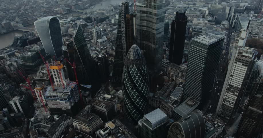 Aerial view of tall office buildings and buildings next to river in the city