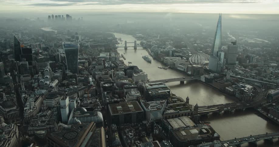 A murky river through a metropolis on a foggy day